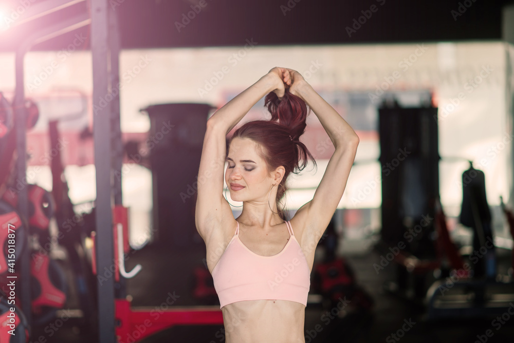 Fitness girl lifting dumbbell in the morning, bottle