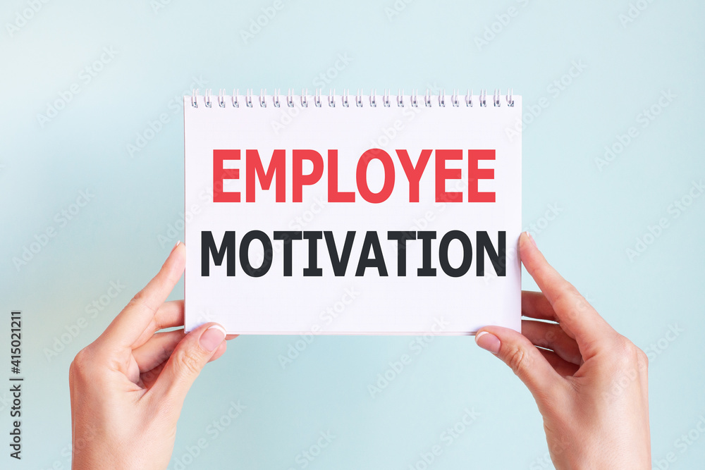 EMPLOYEE MOTIVATION word inscription on white card paper sheet in hands of a woman. Business concept EMPLOYEE MOTIVATION word inscription on white card paper sheet in hands of a woman. Business concept