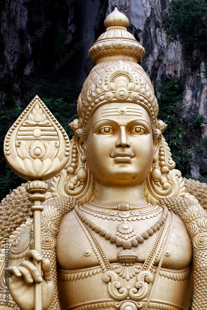 Entrance with the giant statue of Murugan, the Hindu God of War, Hindu Temple and Shrine of Batu Caves, Kuala Lumpur Entrance with the giant statue of Murugan, the Hindu God of War, Hindu Temple and Shrine of Batu Caves, Kuala Lumpur
