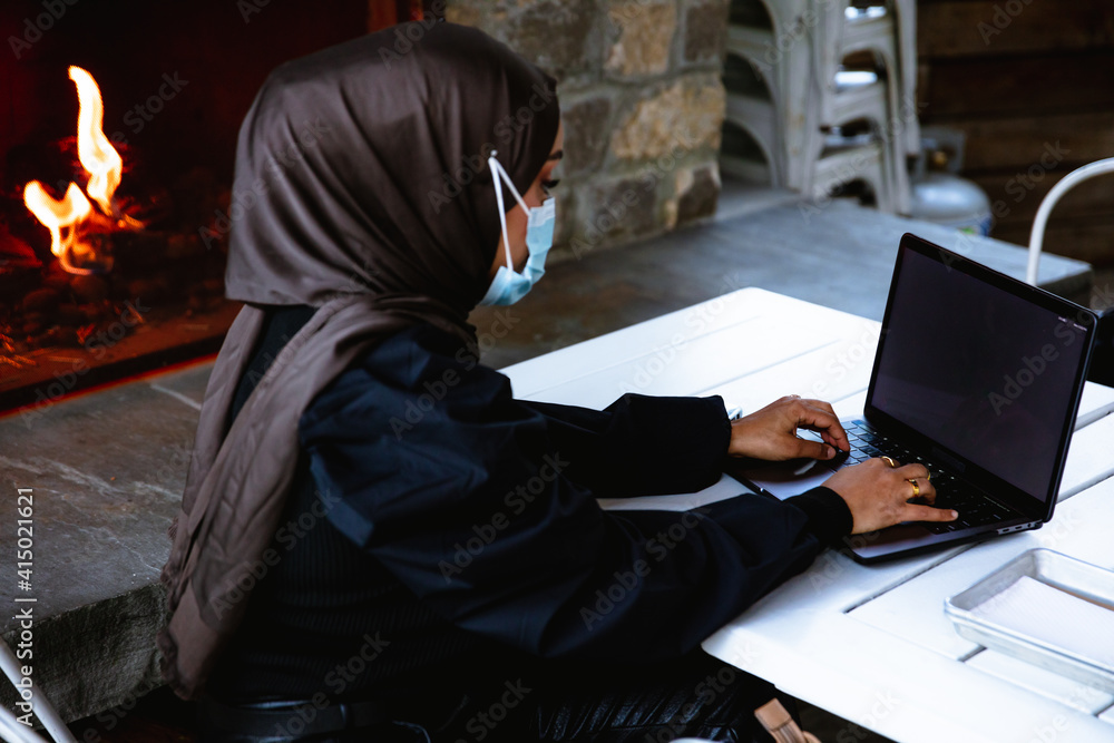 Professional Muslim businesswoman working remote at local coffee shop Professional Muslim businesswoman working remote at local coffee shop