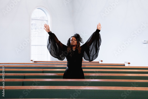 Black woman giving praise and worship to heavenly Father on Easter Sunday