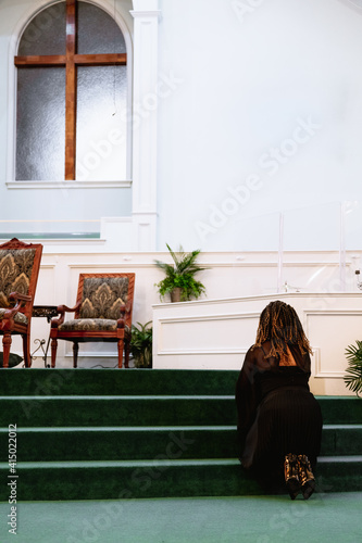 Black woman praying at church to God photo