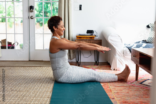 African American woman doing palates core strength training at home