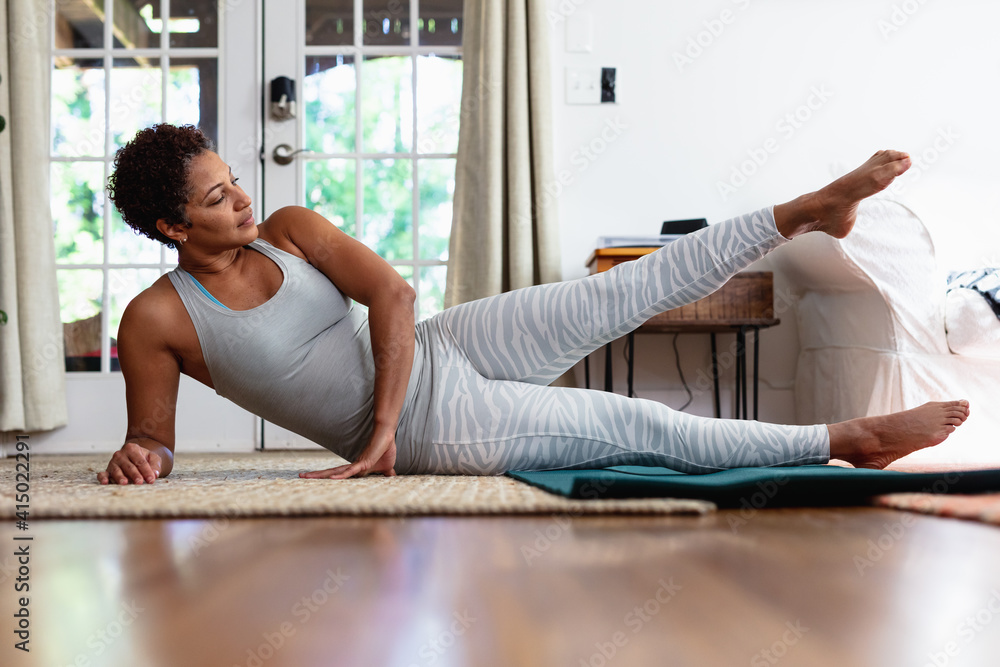 African American woman doing palates core strength training at home African American woman doing palates core strength training at home
