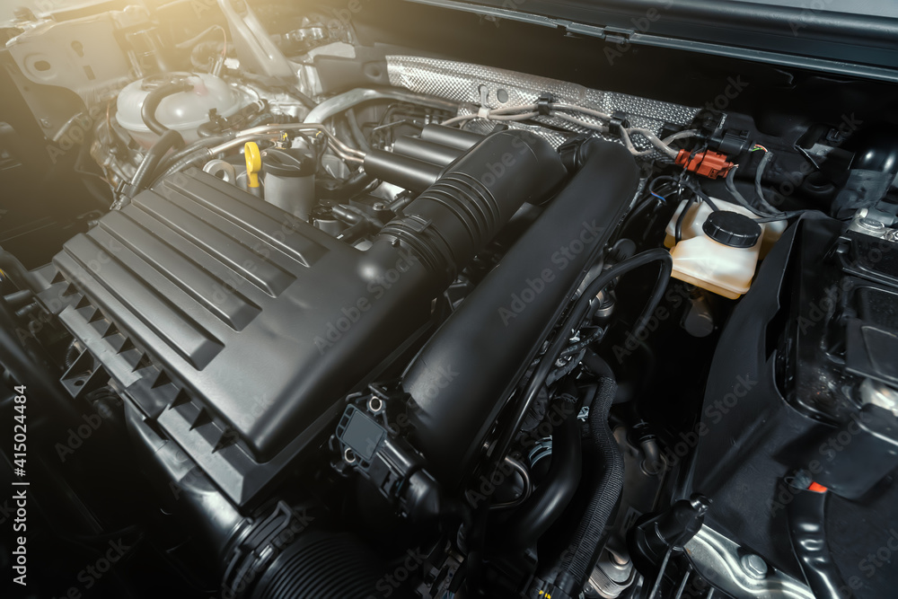 Modern turbocharged eco-friendly engine or motor under vehicle hood close up. Modern turbocharged eco-friendly engine or motor under vehicle hood close up.