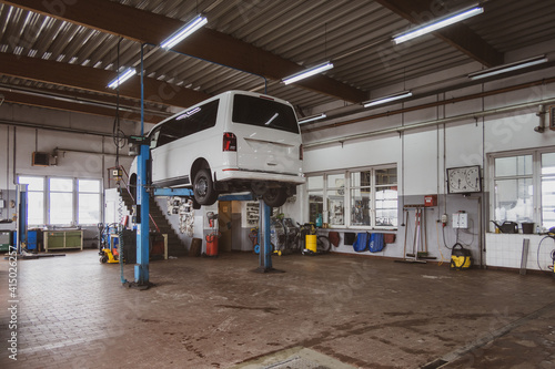 in car workshop there are lifting platforms for repairing cars