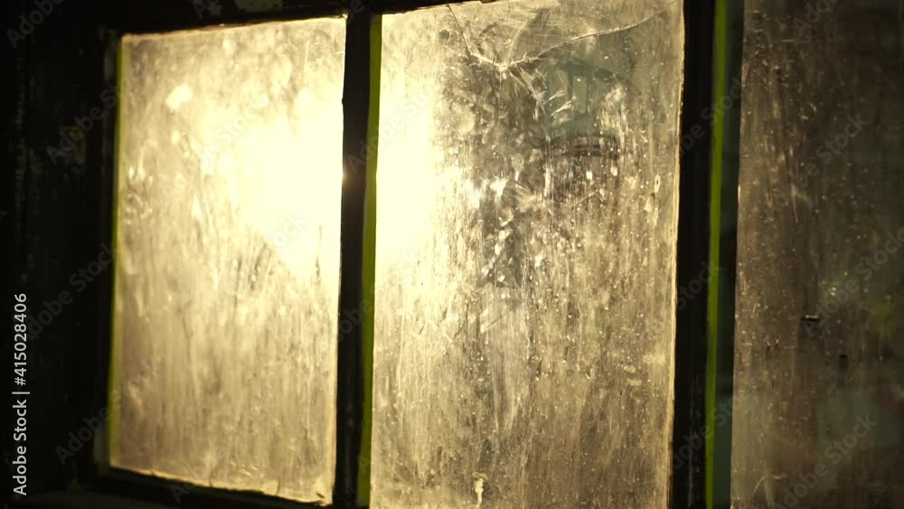 Dirty glass in a dark room. Glass with a crack in the basement with reflection. High quality FullHD footage Dirty glass in a dark room. Glass with a crack in the basement with reflection. High quality FullHD footage