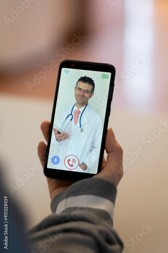 Woman receives medical consultation via smartphone. concept of telemedicine and remote visit via mobile phone