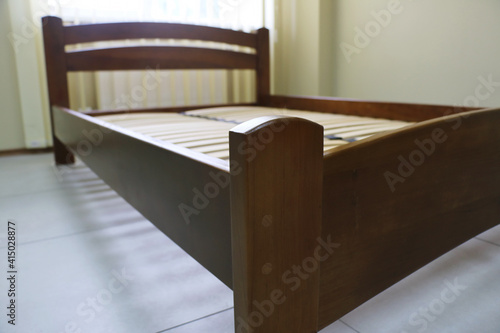 arched wooden bed with slats