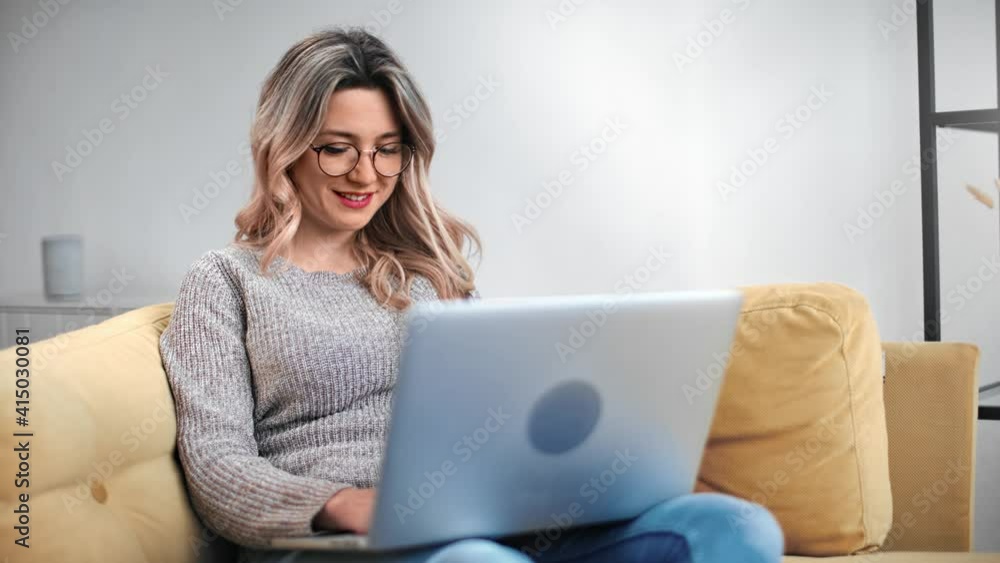 Joyful feminine surfing internet chatting social network use laptop pc. Medium shot on RED camera Joyful feminine surfing internet chatting social network use laptop pc. Medium shot on RED camera
