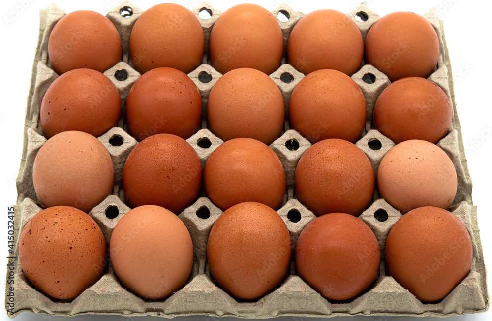 A cardboard box of fresh eggs on a white background A cardboard box of fresh eggs on a white background