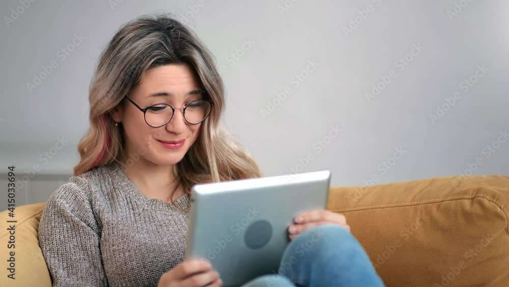 Happy modern woman smiling greeting talking online video call use tablet pc. 4k Dragon RED camera Happy modern woman smiling greeting talking online video call use tablet pc. 4k Dragon RED camera