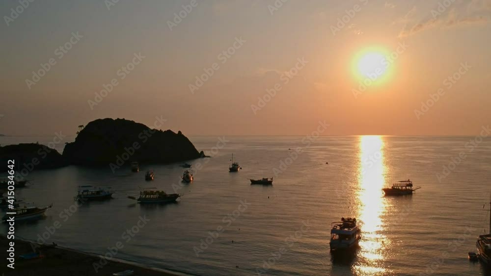 Morning on the beach in the village of Cirali, fishing nets lie on the yellow sand. Boats and ships in the distance of the Taurus mountain are moored near the shore. Landscapes of the Lycian Trail. Morning on the beach in the village of Cirali, fishing nets lie on the yellow sand. Boats and ships in the distance of the Taurus mountain are moored near the shore. Landscapes of the Lycian Trail.
