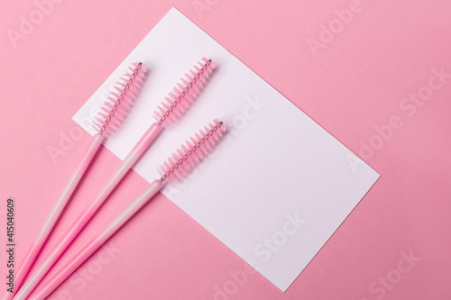 Fotografiet Close up view of brushes for eyebrows and eyelashes extensions on pink backgroun