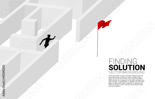 Silhouette of businessman find the way out from maze to red flag. business concept for finding solution and reach goal