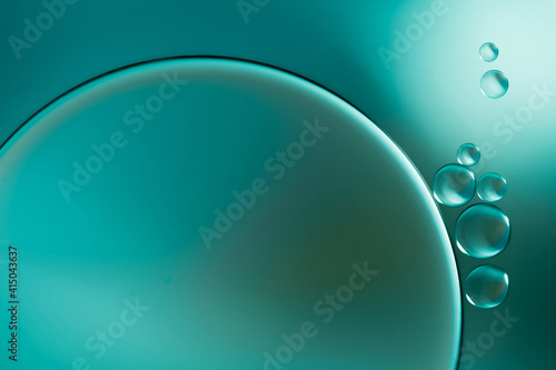 Closeup of abstract background with round shaped cells of vaccine of different sizes illuminated by colorful light