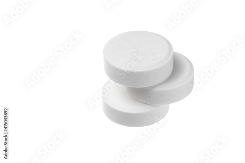 Close-up big round pills isolated on white background. Big white tablets of round shape on white background.