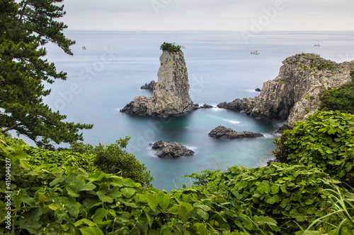 Breathtaking scenery of Oedolgae rock in sea water located on tropical Jeju island in summer photo