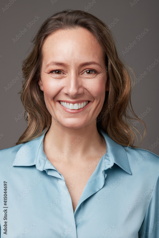 Portrait of happy elegant mature businesswoman standing studio looking at camera Portrait of happy elegant mature businesswoman standing studio looking at camera