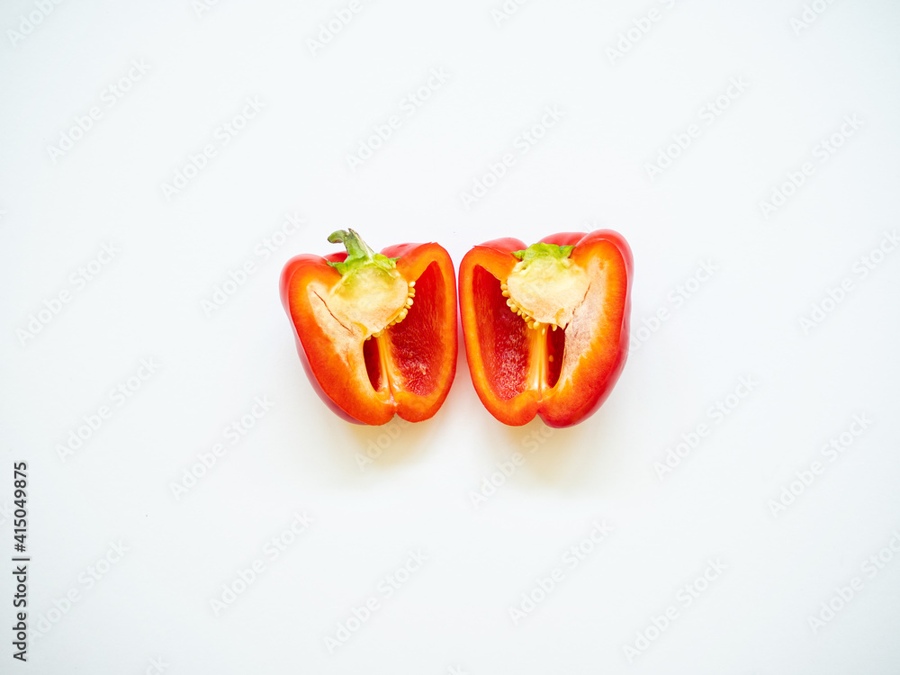 Red bell pepper sliced with seeds isolated in white background Red bell pepper sliced with seeds isolated in white background