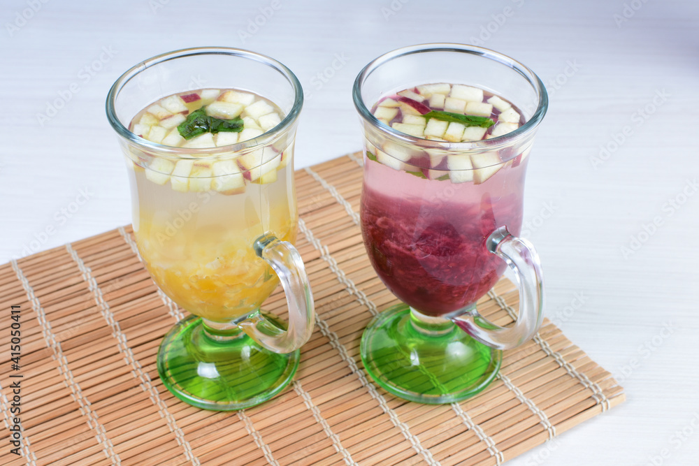 Colorful italian sodas with chopped fruits on white wooden background Colorful italian sodas with chopped fruits on white wooden background