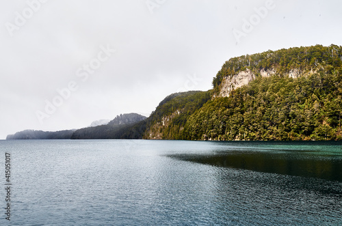 A view of the Nahuel Huapi Lake and rock formations from the docks at Mansa Bay. Villa La Angostura, Neuquen, Argentina. photo