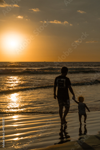 People on the beach with a beatiful sunset