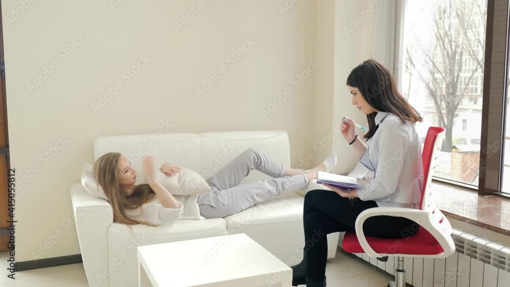 A young girl during depression communicates with a psychologist in the office. Psychological help A young girl during depression communicates with a psychologist in the office. Psychological help