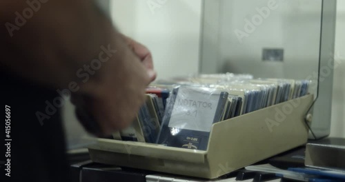 User browsing vintage computer floppy disks