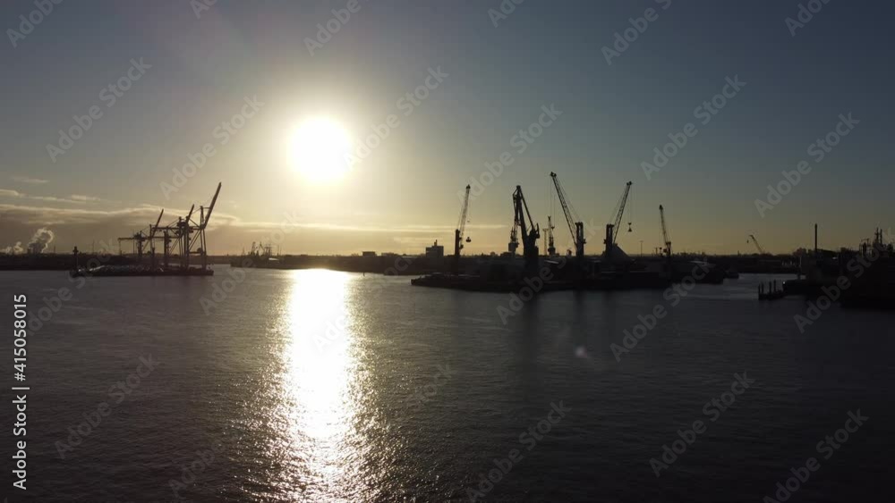 The cranes of Hamburg Harbour in the backlight - aerial view The cranes of Hamburg Harbour in the backlight - aerial view