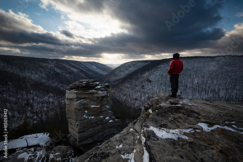 A hiker taking in the view of the Blackwater Canyon in Blackwater Falls State Park on a frigid late Winter evening. photo