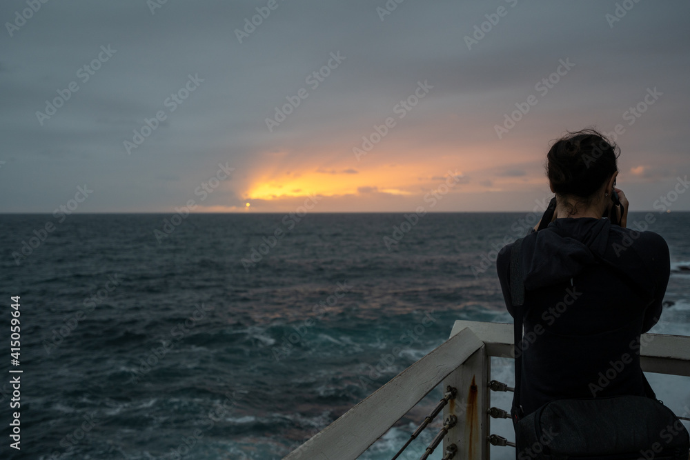 lady person from behind taking photo of sunrise lady person from behind taking photo of sunrise