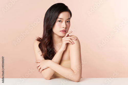 Beautiful young asian woman with clean fresh skin on beige background, Face care, Facial treatment, Cosmetology, beauty and spa, Asian women portrait