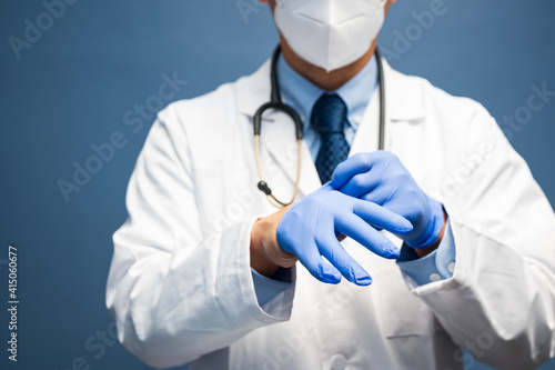 male doctor wears clean protective gloves before examination