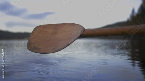 Drops Of Water Falling From The Paddle Into The River. close up