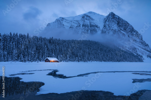 Blue hour at a mostly frozen Lake Louise during the Winter. This lake is an iconic spot in the Canadian Rockies.
