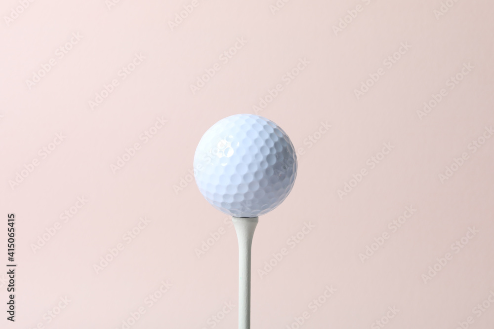a golf ball of various colors with a pink background a golf ball of various colors with a pink background