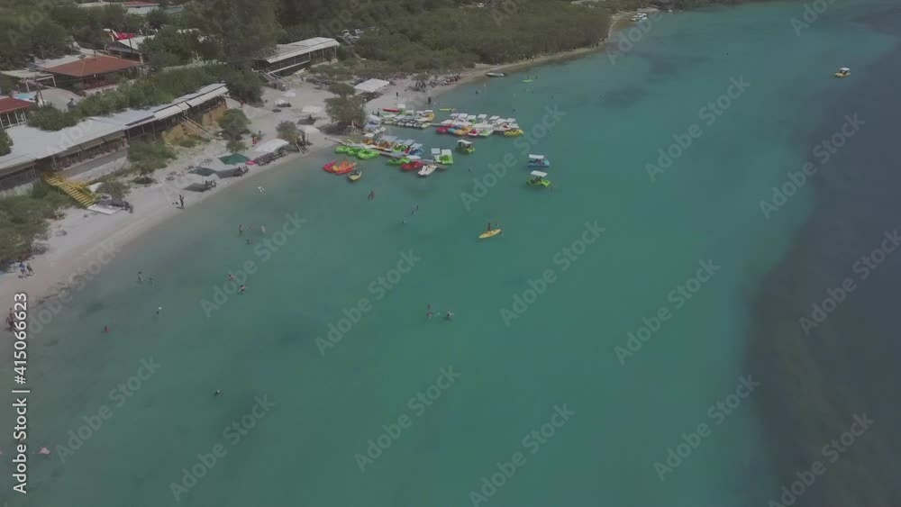 Aerial view of Kournas Lake, Greece. Little pier with pedal boats in the water Aerial view of Kournas Lake, Greece. Little pier with pedal boats in the water