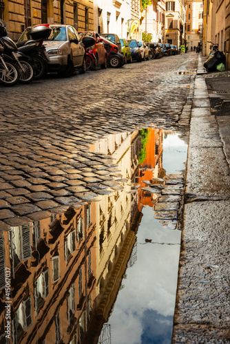 Italy, Rome. Via della Penna, side street west of Via Ripetta, with puddles from the rain and reflection. photo