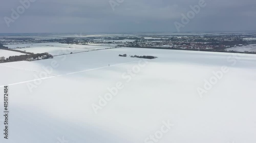 Aerial shot lifting with vast blanket of white untouched snow ahead. Wakering Village in the distance DJI MAVIC 2 PRO HD 60fps photo