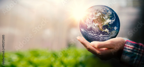 Fototapeta Naklejka Na Ścianę i Meble -  Woman holding earth in her hand, save the earth and energy concept. Earth image courtesy of NASA.