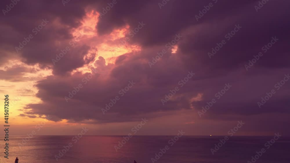 scenery sunset above the ocean large clouds cover the ocean during sunset many tourise are on Kata beach Phuket Thailand. scenery sunset above the ocean large clouds cover the ocean during sunset many tourise are on Kata beach Phuket Thailand.