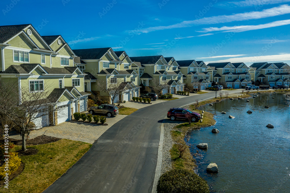 Aerial view of luxury duplex residential neighborhood on a manmade promontory on a curving street in a gated community on Kent Island Narrows Maryland USA