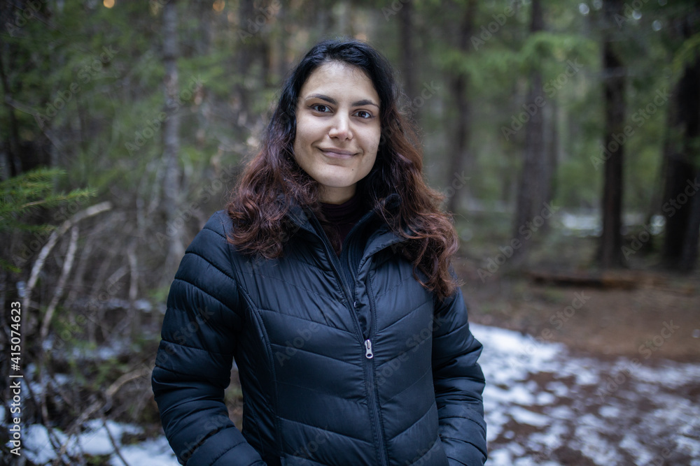 Smiling woman wearing black clothing in the forest Smiling woman wearing black clothing in the forest