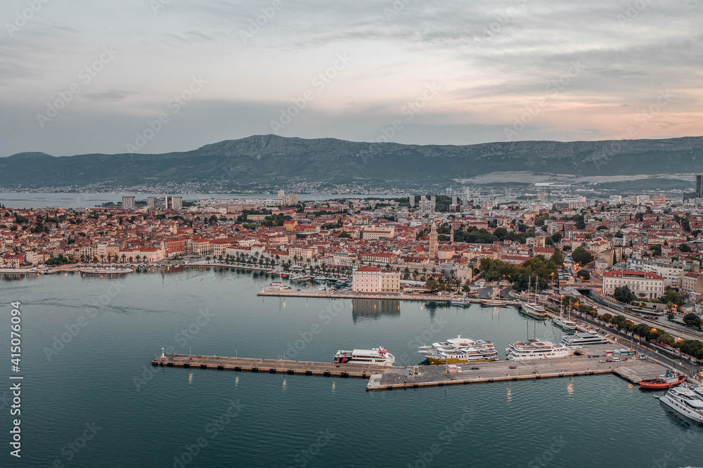 Aerial drone shot of Split old town ferry port with lights before sunrise in morning in Croatia