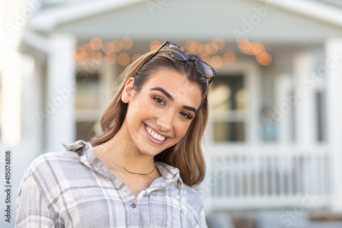 teenager smiling in backyard smiling with house in the background blurred 0319 photo
