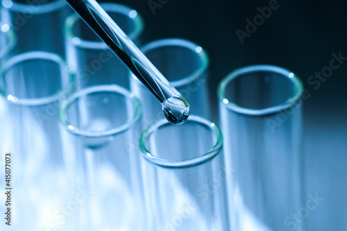 Water droplets experiment with antibiotics in a test tube For creating a vaccine against the coronavirus, COVID-19 and influenza in the laboratory. on white background