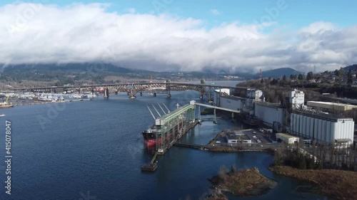 Aerial view of the bridge and grain loading ship in Vancouver harbour