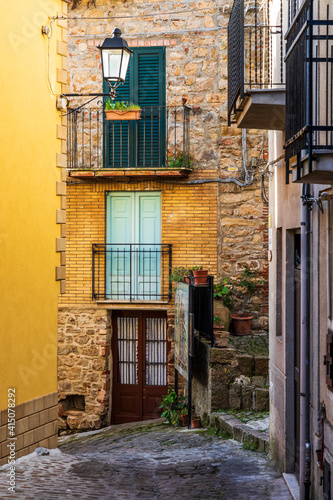 Italy  Sicily  Palermo Province  Pollina. Balconies above a cobblestone city street in Pollina.