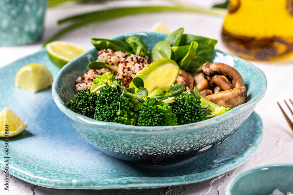 Green vegetable vegan salad with spinach, mushrooms and broccoli and quinoa. Healthy vegetarian food concept. top view Green vegetable vegan salad with spinach, mushrooms and broccoli and quinoa. Healthy vegetarian food concept. top view